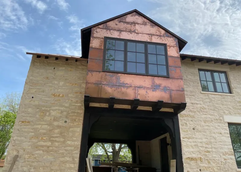 Copper metal panel facade on a stone building for Metal Roof Coating in Northbrook