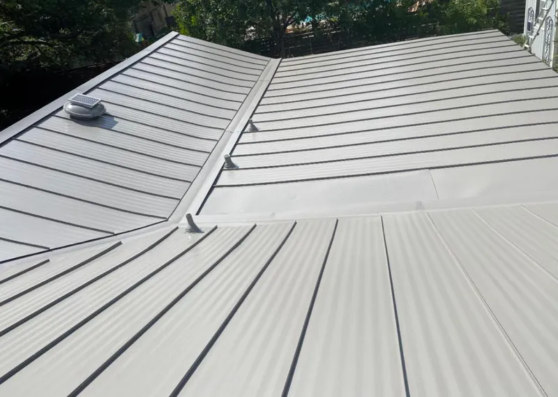 Solar attic fan installed on a metal roof for Roof Ventilation in Northbrook